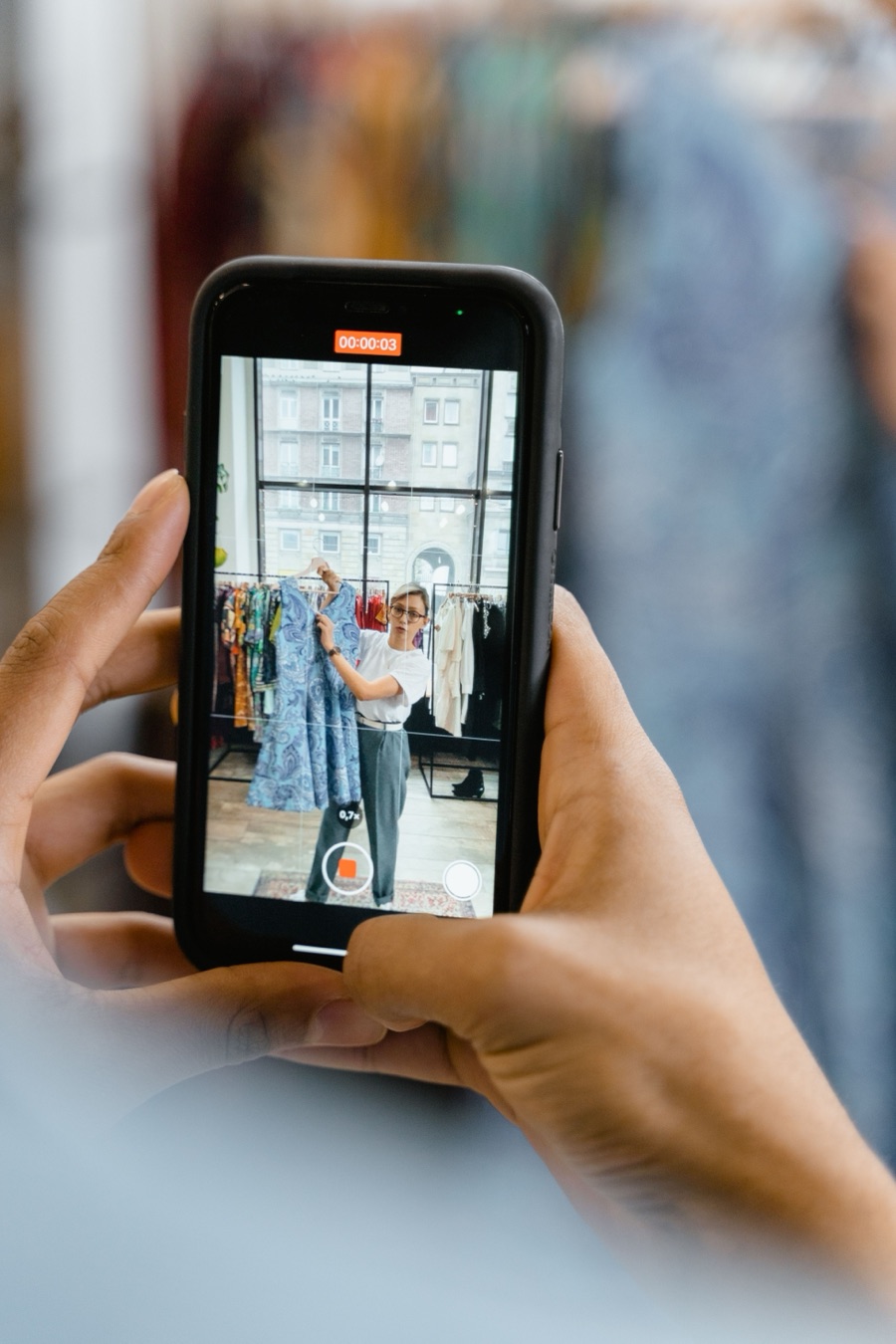 A creator filming a local shop owner on a phone
