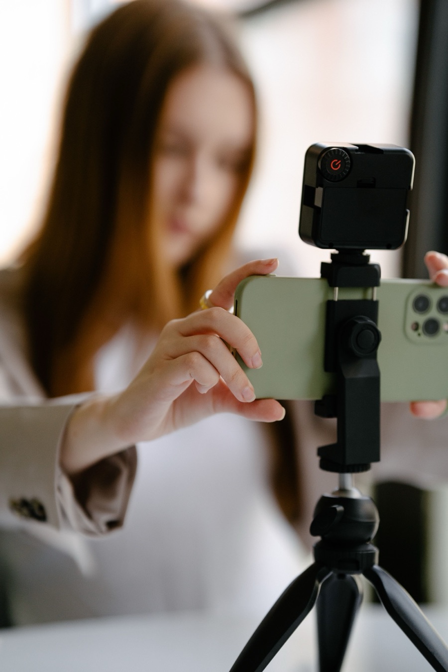 A creator setting up a phone on a tripod to film